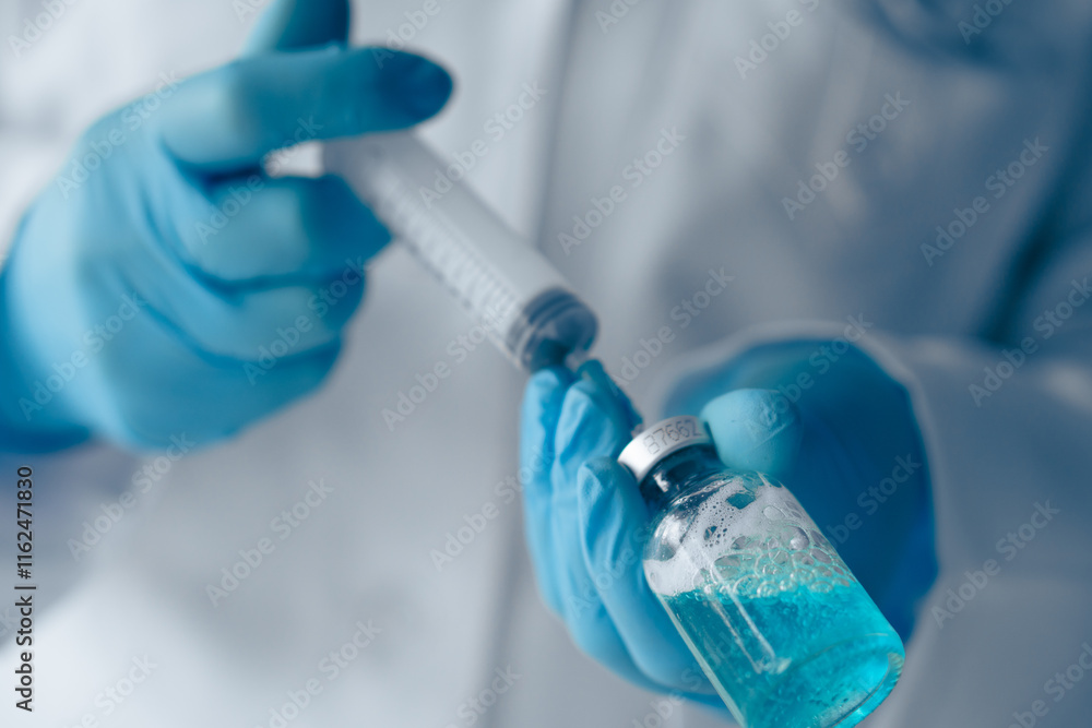 Aufkleber A skilled Laboratory Technician methodically preparing a precise dosage using a syringe and a vial containing a striking blue liquid, indicative of thorough biomedical research and testing