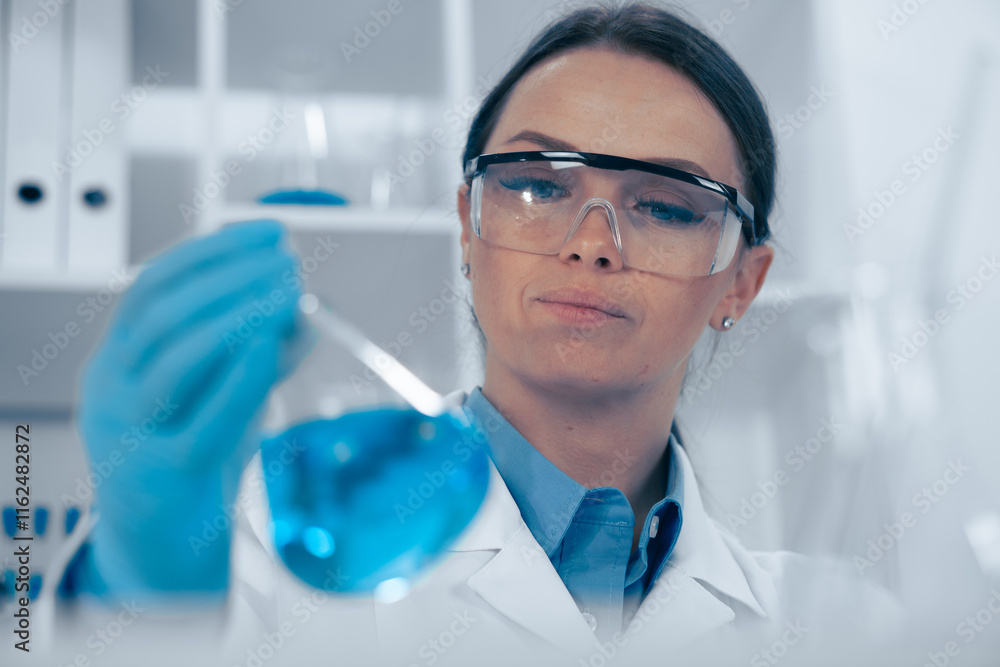 Poster a female scientist is conducting an indepth analysis of a blue solution in her laboratory, showcasin