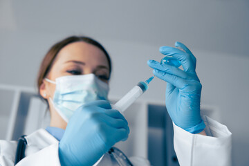 A healthcare professional prepares a vaccine in a sterile setting, following strict safety...