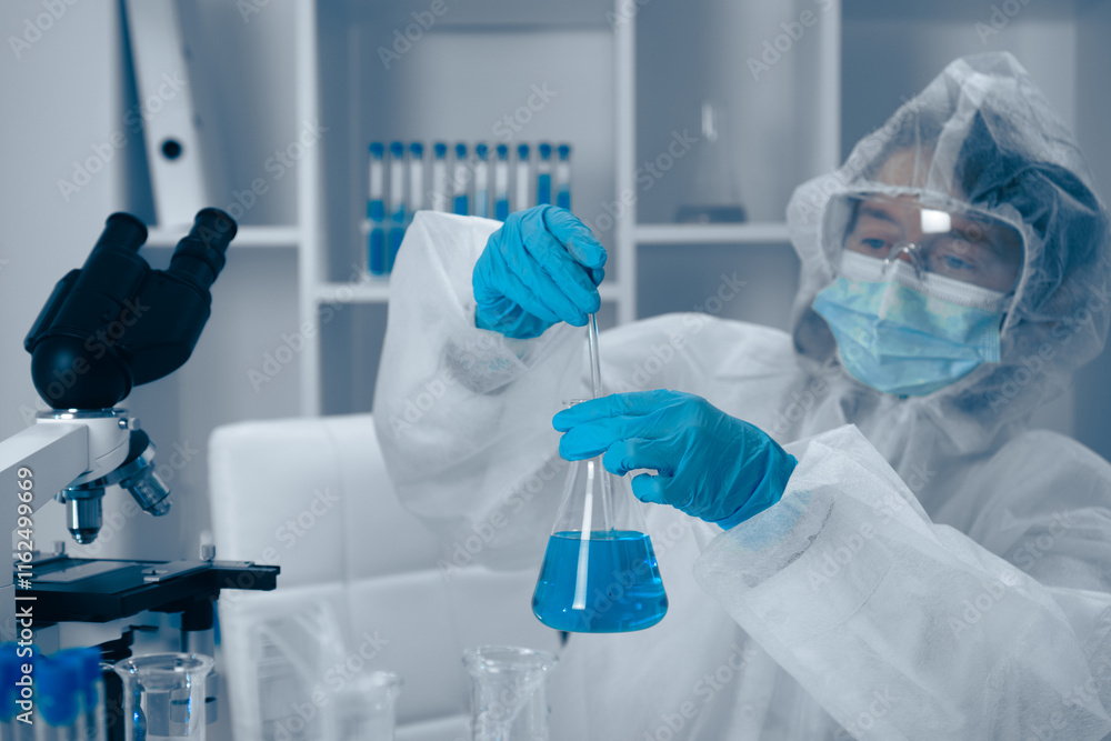 Poster A dedicated scientist is engaged in conducting a meticulous laboratory experiment using a vibrant blue solution as part of their ongoing research effort. They analyze various factors meticulously