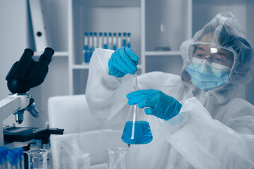 A dedicated scientist is engaged in conducting a meticulous laboratory experiment using a vibrant...