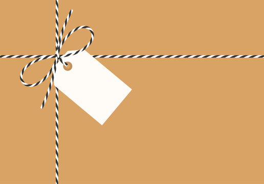 Flat kraft background, gift tied up with cotton black rope bakers twine bow and ribbons with blank white paper tag. Packing string for present, pastry box for New Year, birthday. Vector EPS10