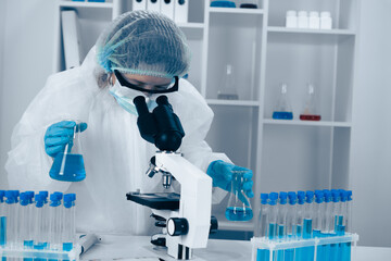 A dedicated scientist diligently engaged in extensive research utilizing advanced laboratory equipment and sophisticated microscopy techniques to conduct critical experiments and analyze data