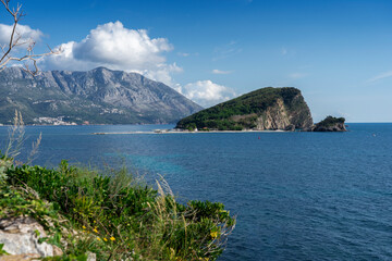 view of the island of Sveti Nikola and Hawaii beach, a small nearby orthodox church. Budva Montenegro 