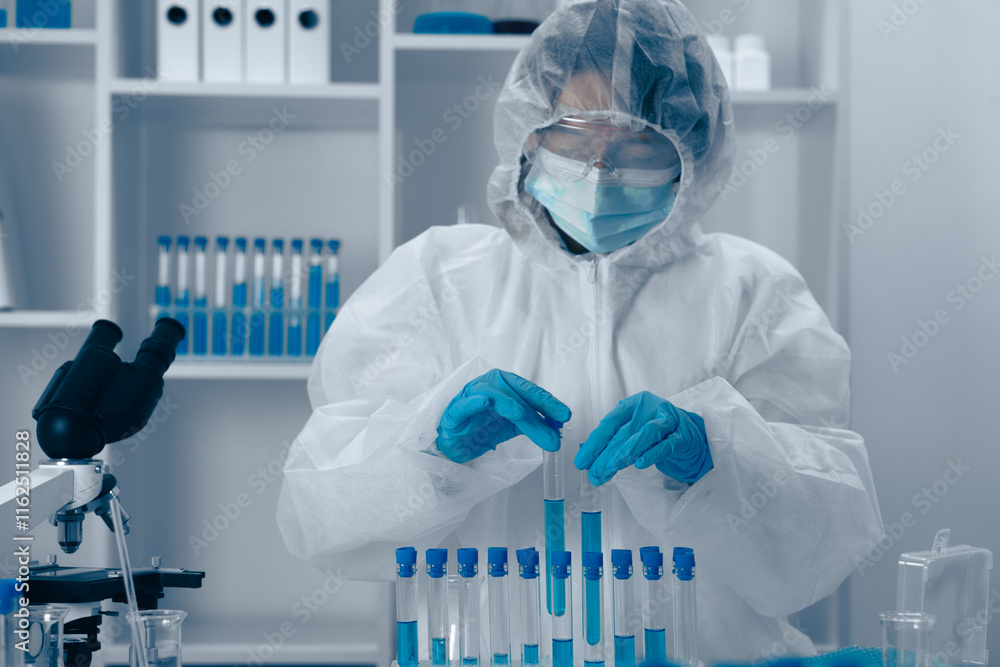 Aufkleber A dedicated scientist is seen in a laboratory where they are conducting various experiments with a collection of test tubes, meticulously analyzing data to advance knowledge in their field of study