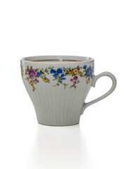 Beautifully decorated porcelain cup showcasing colorful floral designs on a clean white background