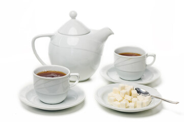 Enjoying a warm tea ceremony with sugar cubes and delicate porcelain in a cozy setting