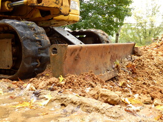 Fototapeta premium Excavator shovel clearing land ready for installation of a new drive 