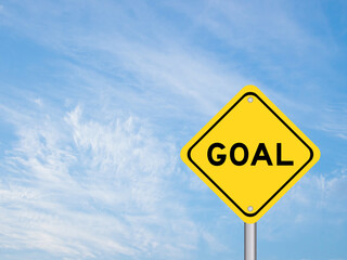 Naklejka premium Yellow transportation sign with word goal on blue color sky background