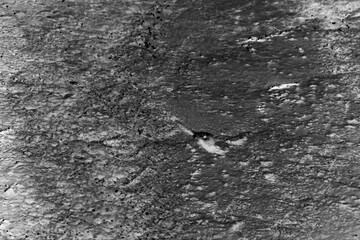 Frozen tundra with ice and water in black and white film negative