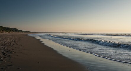 Beach with soft morning light and incoming tide creating a serene picture