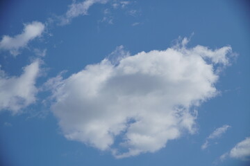 Clear blue sky with a few clouds. The sky is very bright and the clouds are scattered throughout