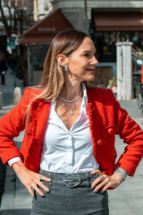 A stylish woman adorned with layered gold and diamond jewelry, 
including necklaces, bracelets, rings.
