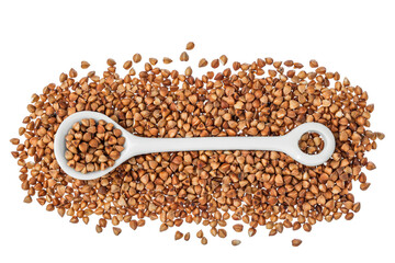 Raw buckwheat in ceramic spoon isolated on white background. Top view. Flat lay