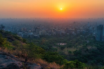 Fototapeta premium A breathtaking sunset over a city skyline, casting warm hues across the horizon, blending urban and natural landscapes in serene beauty.