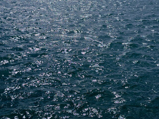 Blue sea glittering shiny water surface.