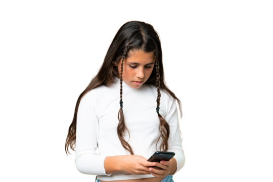 Young girl over isolated chroma key background sending a message with the mobile