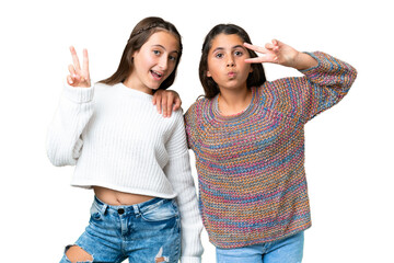 Friends girls over isolated chroma key background smiling and showing victory sign