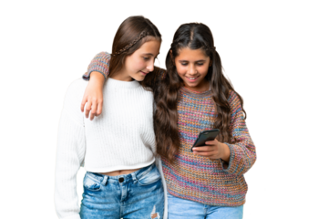 Friends girls over isolated chroma key background sending a message or email with the mobile