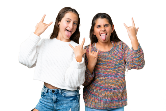 Friends girls over isolated chroma key background making rock gesture