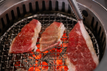 Premium marbled texture wagyu A5 beef steak Japanese restaurant yakiniku grilled on stove