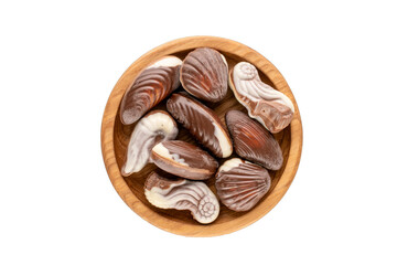 Several chocolate candies with a wooden saucer on a white background, close-up, top view.