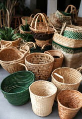A collection of handwoven baskets of various shapes and sizes arranged on the floor for display.