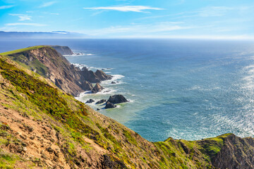 Breathtaking aerial view of Point Reyes, California, showcasing dramatic coastal cliffs surrounded by the Pacific Ocean. A stunning destination for nature lovers, photographers, and outdoor