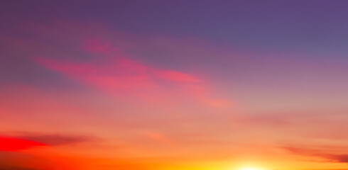 Sky Dusk Background,Sunset Dramatic Pink, Orange, Red,Yellow Sky, Cloud with golden sunlight over sea beach in evening summer,Nature landscape banner,Horizon Sunrise sky pastel blue,purple in morning