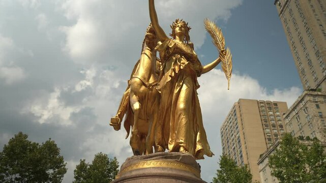 A detailed view of the golden statue of General Sherman near Central Park in New York City. The sculpture showcases intricate artistry and historic significance.