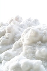 A large pile of snow sits atop a snowy ground, perfect for winter scenes or outdoor activities