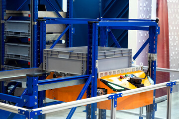 Warehouse robot for vertical movement of products. AMR rises to second tier of rack. Warehouse...