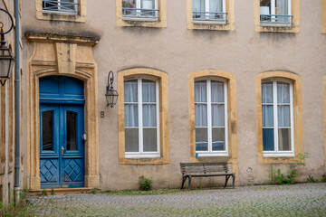 porte cochère bleue en bois avec des fenêtres sur une façade