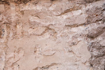 Rough uneven surface of a concrete wall.