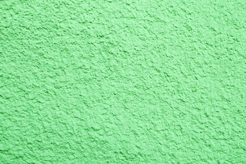 Abstract background of green plaster close-up.