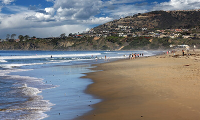 Beachcombers along the shore at Dana Point, California, in Orange County