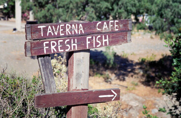 Wooden signpost - tavern cafe, fresh fish