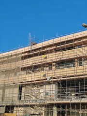 Scaffolding Erected Around Under Construction Building. 
Safety Scaffolding Protection Covered The Front Of Under Construction Skyline 
03 Floor Residential Under Construction Tower Structure 