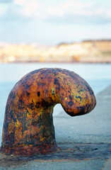 Close-up of a mooring iron bollard on a pier