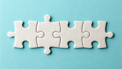 Four white puzzle pieces are aligned in a straight row against a light blue background. The pieces fit together perfectly, creating a seamless connection.AI generated.