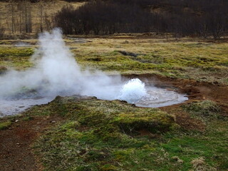Strokkur geyser, beginning of an eruption of boiling water near Geysir in Iceland in Haukadalur