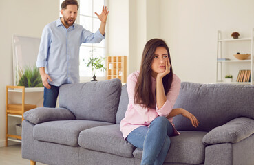 Man gestures in middle of argument or trying to explain something to woman who seems indifferent....