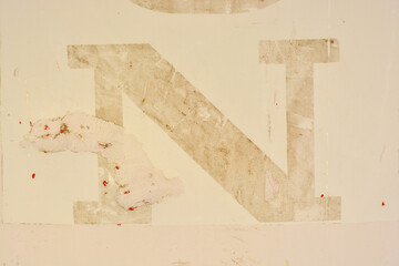 letter n deleted on pale yellow ochre