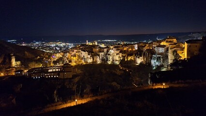 The old town of Cuenca with its iconic Hanging Houses illuminated at night, Castilla-La Mancha, Spain, offering a stunning view of architectural and historical charm