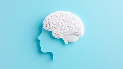 Recognizing mental health by using a head-shaped paper cutout and a brain illustration.