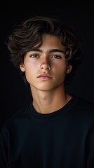 Obraz premium Expressive teen portrait with artistic lighting in studio setting for creative design