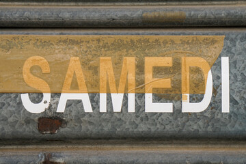 samedi letter with duct tape on metal roller shutter