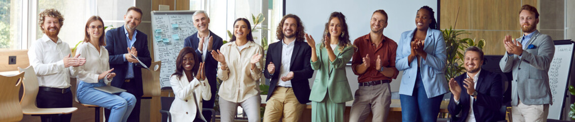 Group of multiethnic happy business people men and women looking at the camera, smiling and...
