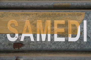 samedi letter with duct tape on metal roller shutter