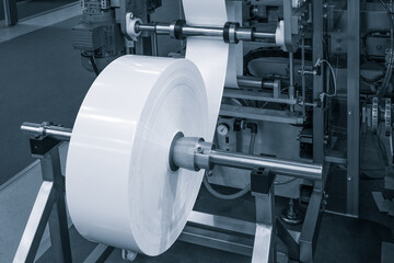 Fragment of the conveyor of sticking labeling machine. Abstract industrial background.